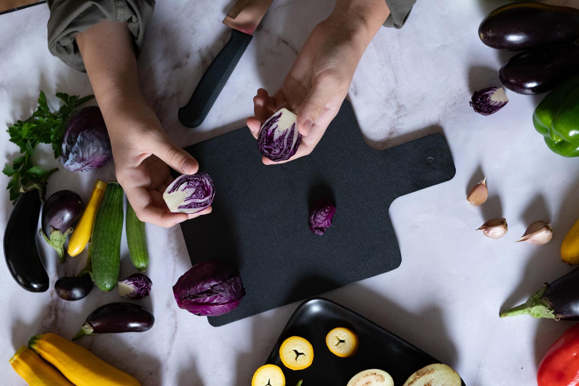 Close-up of ingredients on butcher block with hands